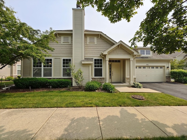 1931 Chase Ln Unit 1931, Aurora, IL 60502 - view of front of house featuring asphalt driveway, a garage, stone siding, a front yard, and a chimney