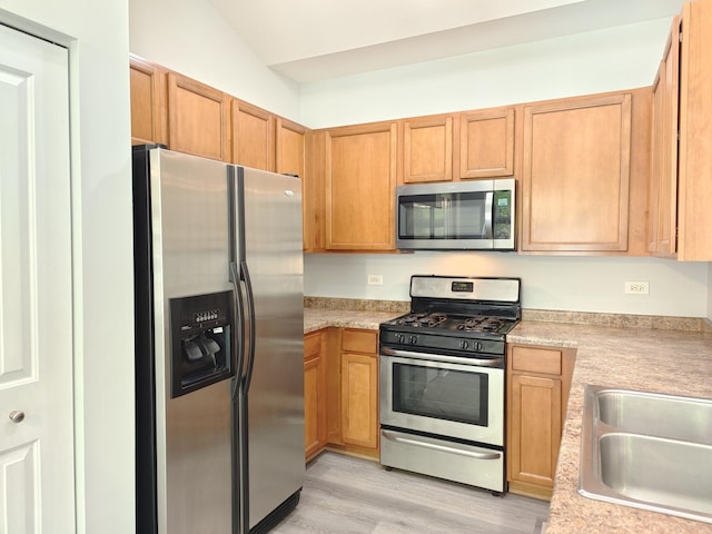 1931 Chase Ln Unit 1931, Aurora, IL 60502 - kitchen with appliances with stainless steel finishes, light countertops, light wood-style flooring, vaulted ceiling, and a sink
