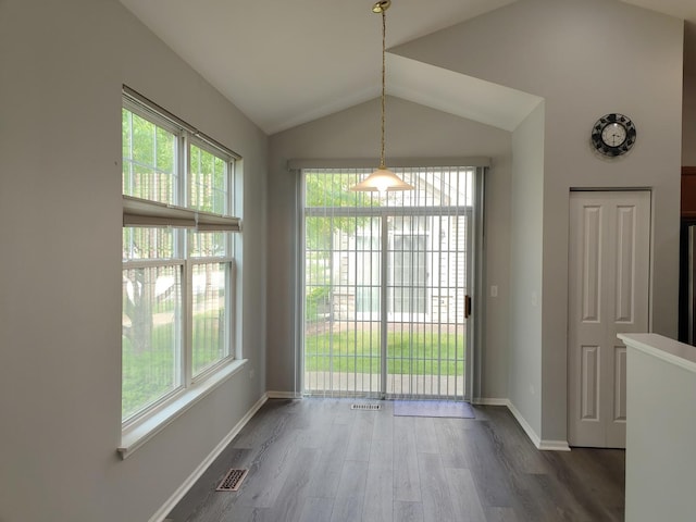 1931 Chase Ln Unit 1931, Aurora, IL 60502 - unfurnished dining area with plenty of natural light, wood finished floors, lofted ceiling, and baseboards