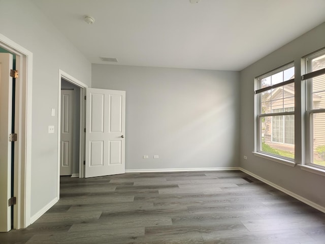 1931 Chase Ln Unit 1931, Aurora, IL 60502 - unfurnished room featuring wood finished floors, baseboards, and a smoke detector