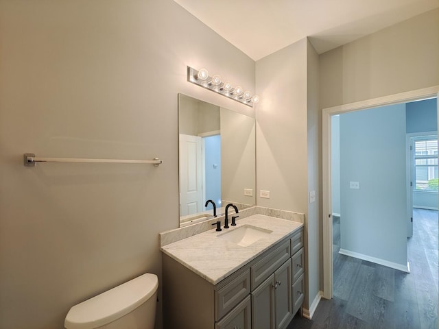 1931 Chase Ln Unit 1931, Aurora, IL 60502 - bathroom featuring vanity, wood finished floors, toilet, and baseboards