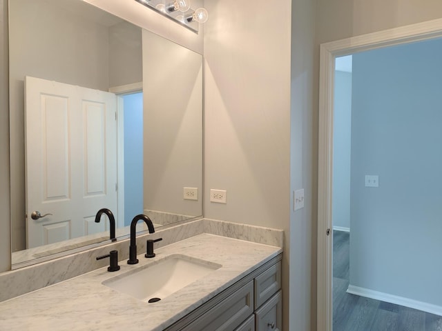 1931 Chase Ln Unit 1931, Aurora, IL 60502 - bathroom with vanity, wood finished floors, and baseboards