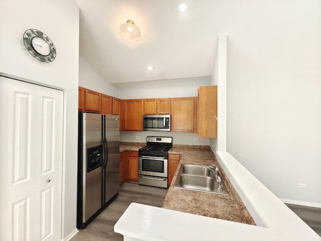 1931 Chase Ln Unit 1931, Aurora, IL 60502 - kitchen featuring stainless steel appliances, vaulted ceiling, a sink, light countertops, and wood finished floors