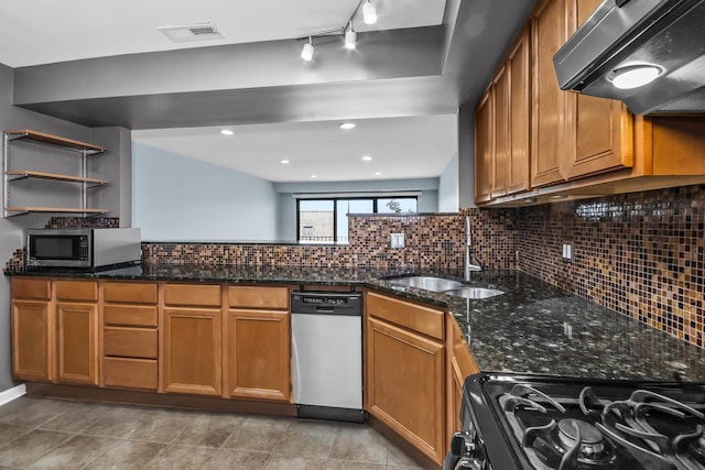 7200 N Ridge Blvd Unit 4H, Chicago, IL 60645 - kitchen featuring appliances with stainless steel finishes, range hood, backsplash, and brown cabinets