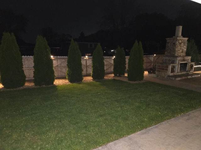 7225 Poplar Ln, Darien, IL 60561 - yard at night featuring a fireplace