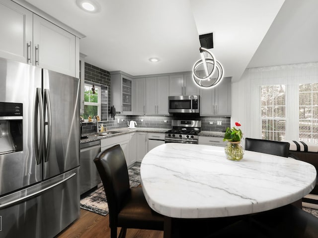 7225 Poplar Ln, Darien, IL 60561 - kitchen featuring appliances with stainless steel finishes, gray cabinets, backsplash, light stone counters, and recessed lighting
