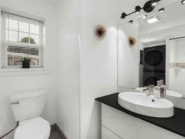 7225 Poplar Ln, Darien, IL 60561 - bathroom featuring stacked washer / drying machine, vanity, and toilet