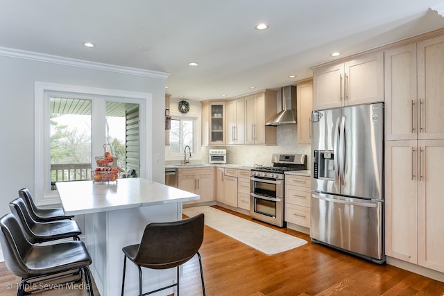 1406 Edgefield Ln, Hoffman Estates, IL 60169 - kitchen with stainless steel appliances, wall chimney exhaust hood, crown molding, light countertops, and a kitchen bar