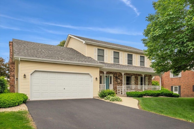 10 S Canterbury Rd, Aurora, IL 60506 - traditional-style house featuring covered porch, asphalt driveway, an attached garage, and a front lawn