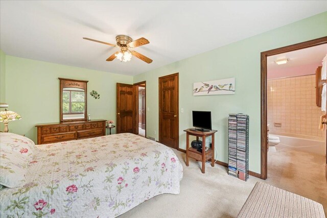10 S Canterbury Rd, Aurora, IL 60506 - bedroom featuring light colored carpet, ensuite bath, baseboards, and a ceiling fan
