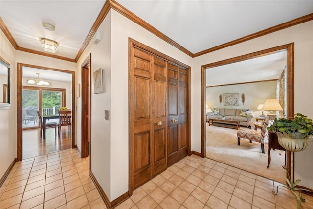 10 S Canterbury Rd, Aurora, IL 60506 - entryway with light tile patterned flooring, a chandelier, light colored carpet, baseboards, and ornamental molding