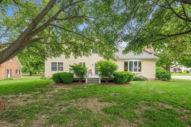 10 S Canterbury Rd, Aurora, IL 60506 - back of property with a lawn, a deck, and a chimney