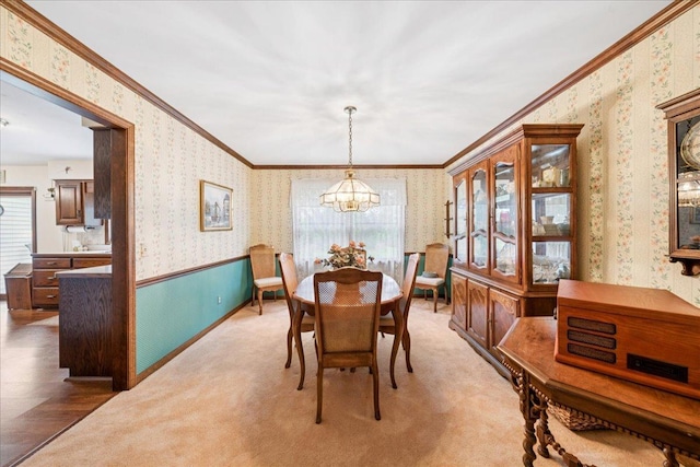10 S Canterbury Rd, Aurora, IL 60506 - carpeted dining room with wallpapered walls, a chandelier, plenty of natural light, ornamental molding, and wainscoting