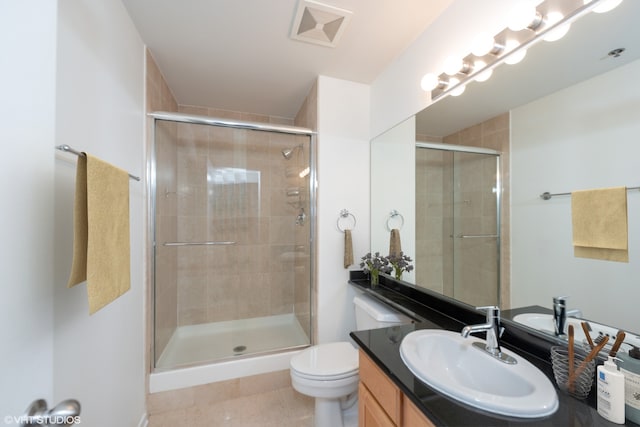 500 S Clinton St Unit 604, Chicago, IL 60607 - bathroom featuring vanity, a stall shower, toilet, and tile patterned floors