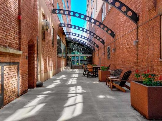 500 S Clinton St Unit 604, Chicago, IL 60607 - building lobby with high vaulted ceiling and brick wall