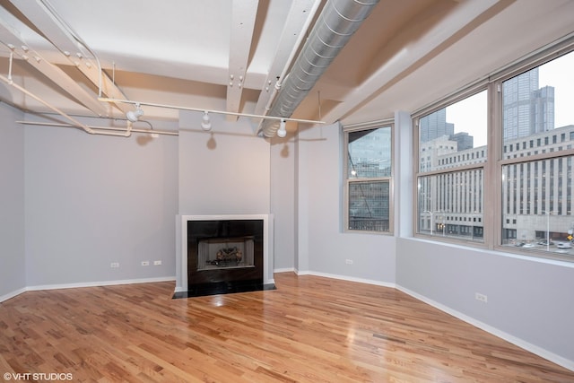 500 S Clinton St Unit 604, Chicago, IL 60607 - unfurnished living room featuring wood finished floors, baseboards, and a fireplace
