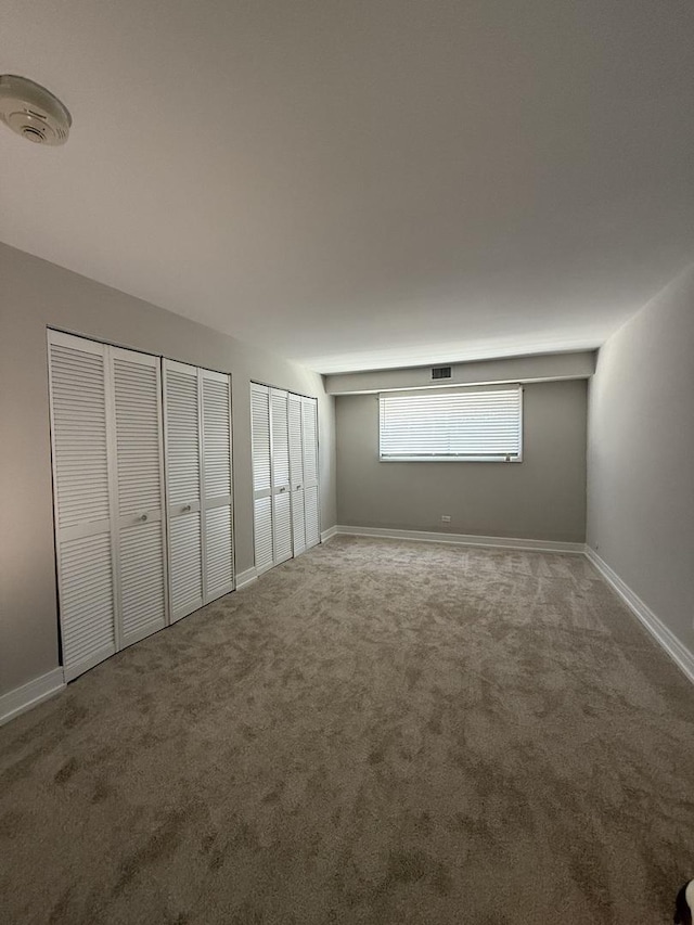 4508 Beau Monde Dr Unit 5, Lisle, IL 60532 - unfurnished bedroom with multiple closets and carpet