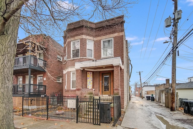 5514 S Winchester Ave, Chicago, IL 60636 - townhome / multi-family property featuring brick siding, a fenced front yard, and a gate