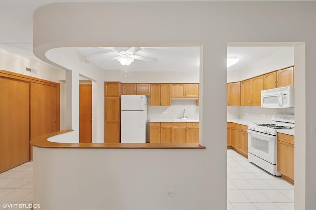 650 S River Rd Unit 405, Des Plaines, IL 60016 - kitchen with white appliances, a sink, decorative backsplash, ceiling fan, and light countertops