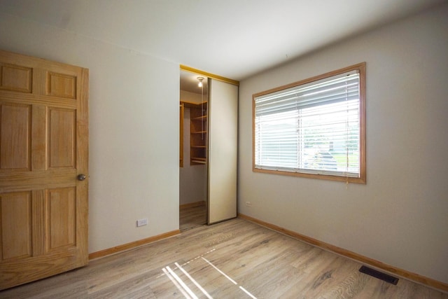 468 Independence Ln, Bolingbrook, IL 60440 - unfurnished bedroom with a closet, light wood-type flooring, and baseboards