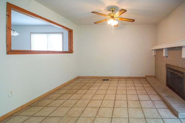 468 Independence Ln, Bolingbrook, IL 60440 - unfurnished living room with ceiling fan, a brick fireplace, baseboards, and light tile patterned floors