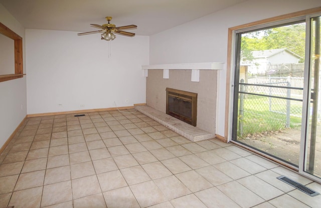 468 Independence Ln, Bolingbrook, IL 60440 - unfurnished living room featuring a brick fireplace, ceiling fan, light tile patterned floors, and baseboards