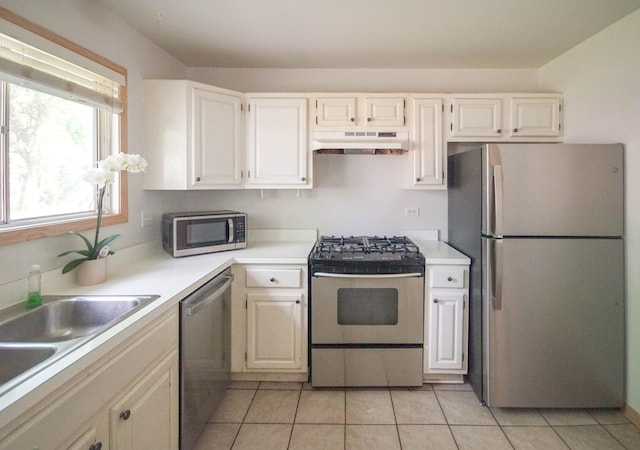 468 Independence Ln, Bolingbrook, IL 60440 - kitchen featuring stainless steel appliances, under cabinet range hood, light tile patterned floors, a sink, and light countertops