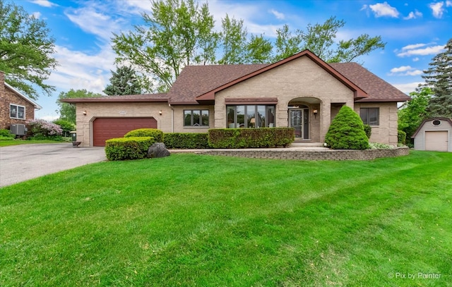 25827 W Andrew Ct, Ingleside, IL 60041 - view of front of house featuring a front yard, driveway, brick siding, a garage, and central AC unit