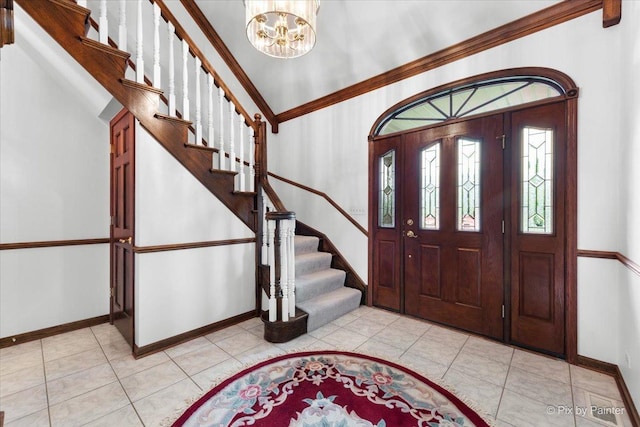25827 W Andrew Ct, Ingleside, IL 60041 - foyer with baseboards, a chandelier, stairs, light tile patterned floors, and crown molding