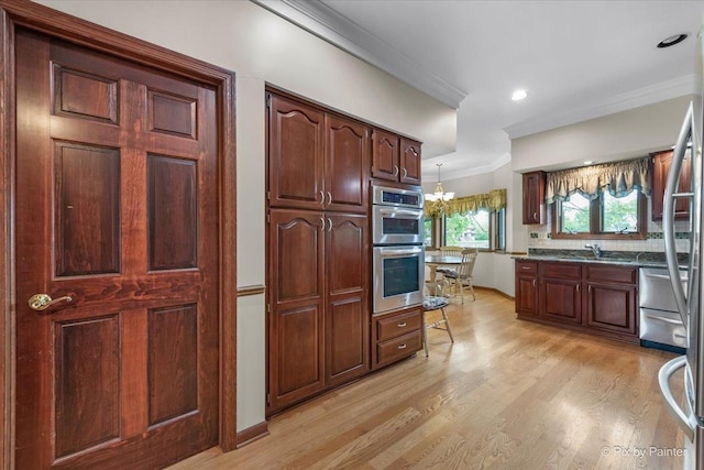 25827 W Andrew Ct, Ingleside, IL 60041 - kitchen with double oven, light wood finished floors, crown molding, a sink, and a chandelier