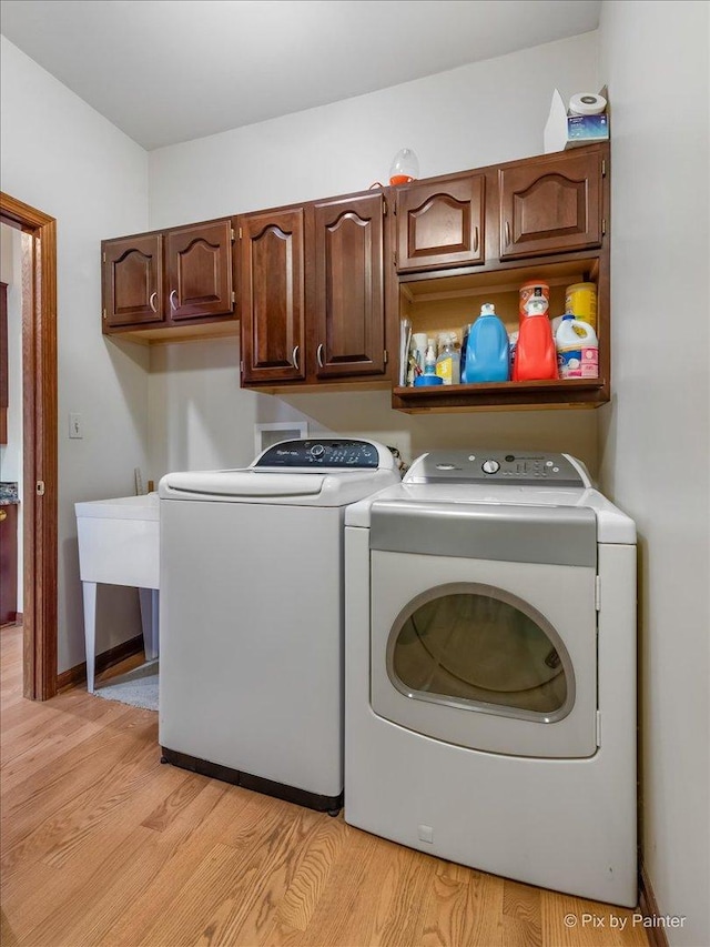 25827 W Andrew Ct, Ingleside, IL 60041 - washroom featuring washer and dryer, cabinet space, and light wood-style floors