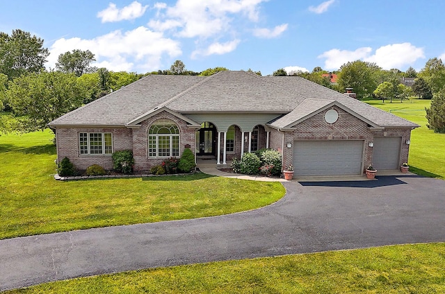 26644 S Ridgeland Ave, Monee, IL 60449 - french country home featuring an attached garage, brick siding, asphalt driveway, and a front lawn