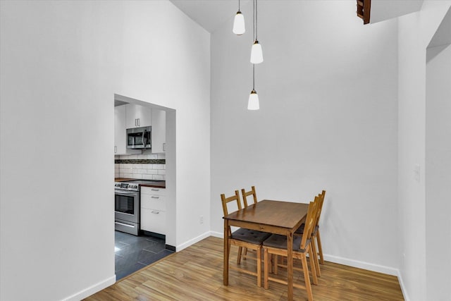 1910 Melrose Dr Unit C, Champaign, IL 61820 - dining space featuring dark wood-style flooring and baseboards