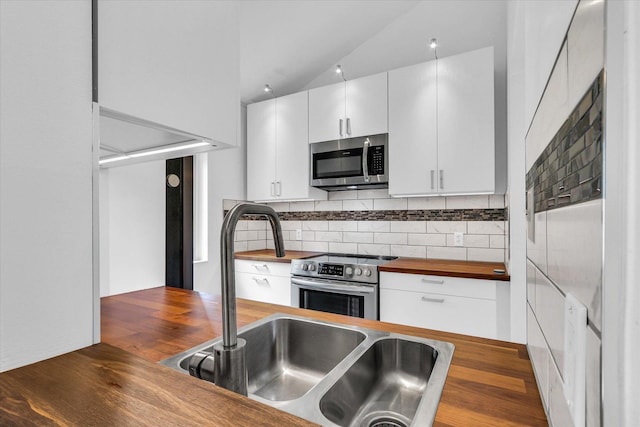 1910 Melrose Dr Unit C, Champaign, IL 61820 - kitchen featuring appliances with stainless steel finishes, wooden counters, white cabinetry, decorative backsplash, and a sink