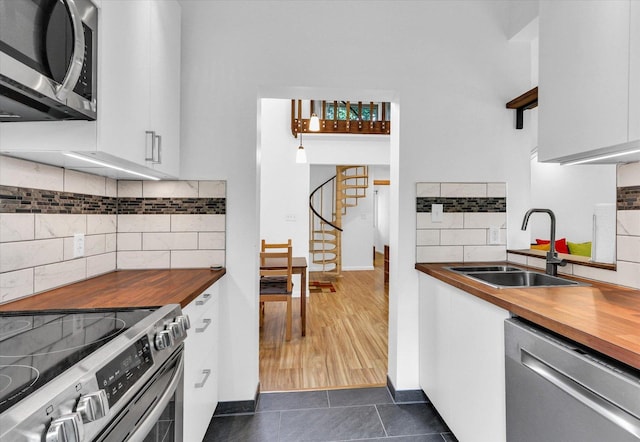 1910 Melrose Dr Unit C, Champaign, IL 61820 - kitchen featuring appliances with stainless steel finishes, butcher block countertops, a sink, and decorative backsplash