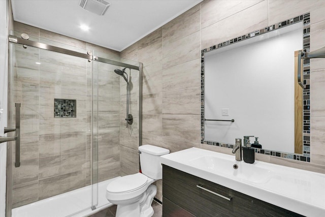 1910 Melrose Dr Unit C, Champaign, IL 61820 - bathroom with tile walls, vanity, a shower stall, and toilet