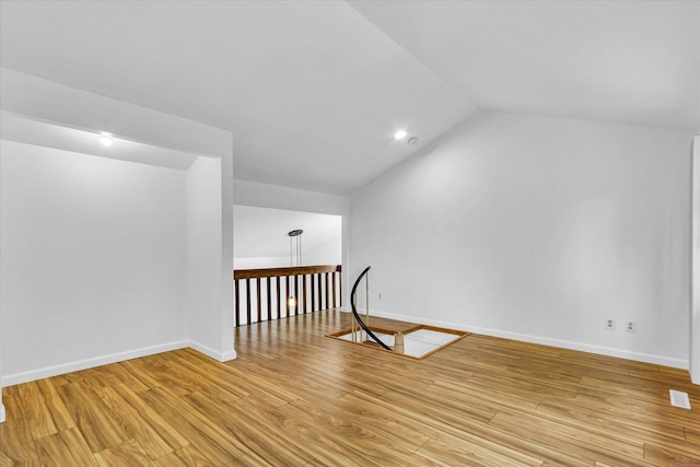 1910 Melrose Dr Unit C, Champaign, IL 61820 - empty room featuring vaulted ceiling, light wood-style flooring, and baseboards