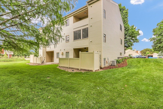 1910 Melrose Dr Unit C, Champaign, IL 61820 - back of house with cooling unit and a lawn