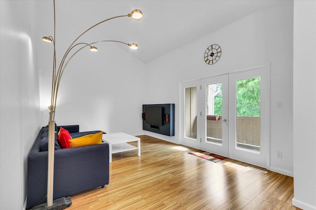 1910 Melrose Dr Unit C, Champaign, IL 61820 - living room featuring high vaulted ceiling, wood finished floors, and baseboards