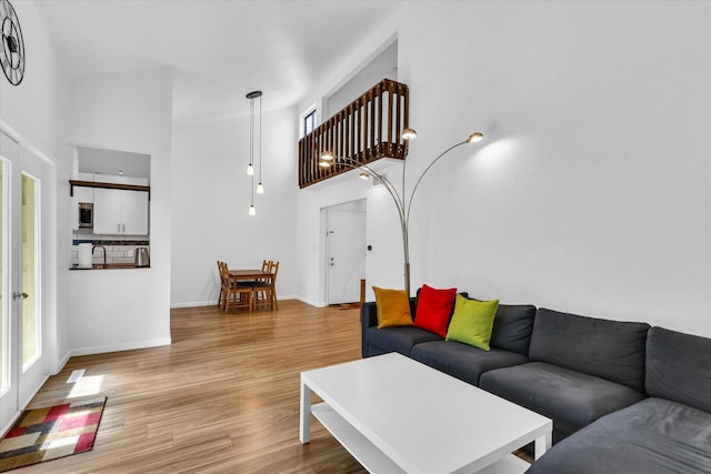 1910 Melrose Dr Unit C, Champaign, IL 61820 - living room with a high ceiling, light wood finished floors, and baseboards