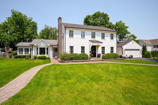 714 Turner Ave, Glen Ellyn, IL 60137 - colonial house featuring a chimney, a front yard, and a garage