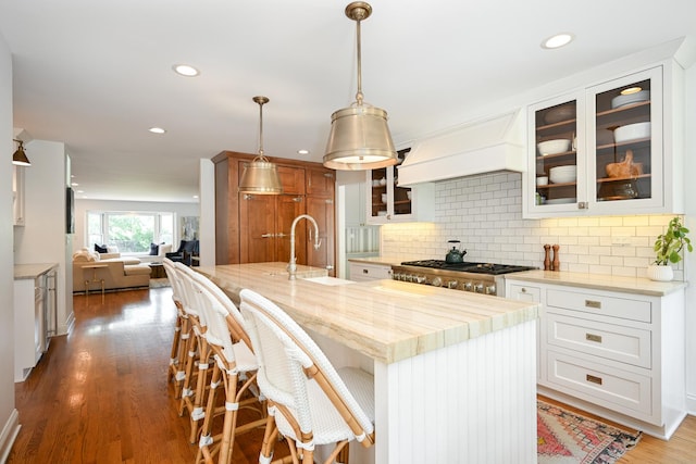 714 Turner Ave, Glen Ellyn, IL 60137 - kitchen with decorative backsplash, glass insert cabinets, recessed lighting, open floor plan, and light stone counters