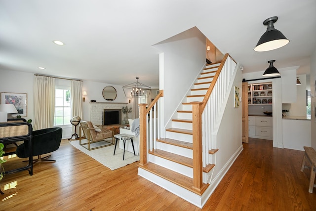 714 Turner Ave, Glen Ellyn, IL 60137 - stairway with wood finished floors, a fireplace with raised hearth, and recessed lighting