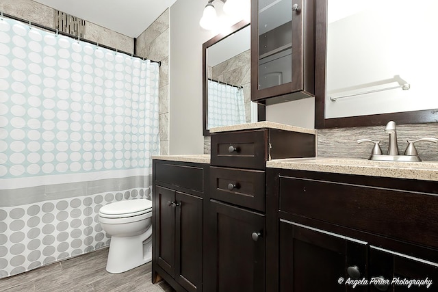 1381 Regency Ln, Lake Villa, IL 60046 - bathroom featuring vanity, toilet, wood finished floors, a shower with curtain, and wainscoting