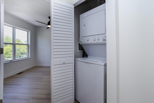 34382 N Aster Ct, Round Lake Beach, IL 60073 - laundry room featuring stacked washing machine and dryer, light wood-type flooring, a ceiling fan, and baseboards