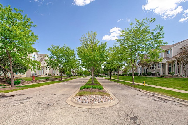 34382 N Aster Ct, Round Lake Beach, IL 60073 - view of asphalt street with a residential view, sidewalks, and curbs