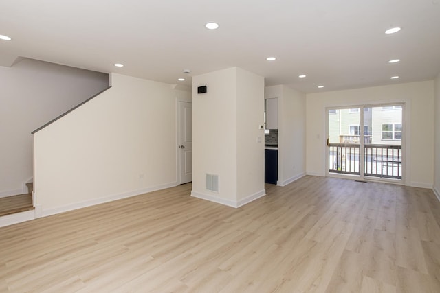 34382 N Aster Ct, Round Lake Beach, IL 60073 - unfurnished living room featuring light wood finished floors, recessed lighting, baseboards, and stairs