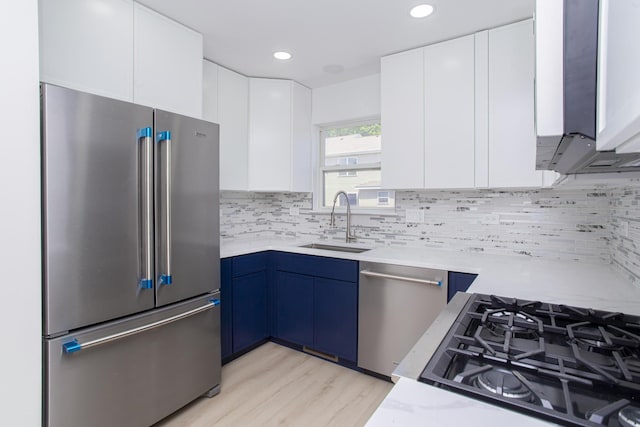 34382 N Aster Ct, Round Lake Beach, IL 60073 - kitchen featuring stainless steel appliances, a sink, blue cabinets, white cabinetry, and recessed lighting