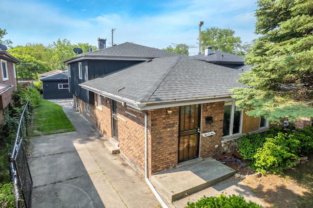 505 E 146th St, Dolton, IL 60419 - rear view of property with a shingled roof and brick siding