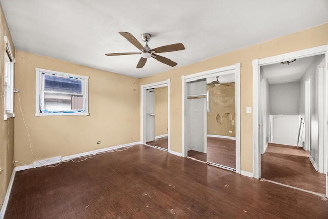 505 E 146th St, Dolton, IL 60419 - unfurnished bedroom featuring two closets, wood finished floors, baseboards, and ceiling fan